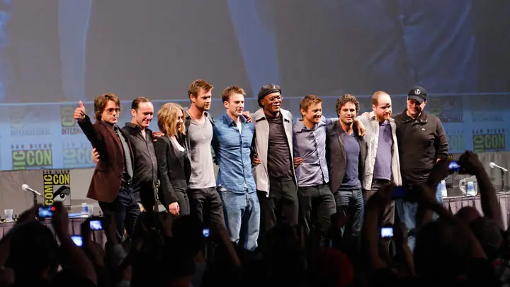 The Avengers cast and filmmakers stand arm in arm on stage at San Diego Comic-Con